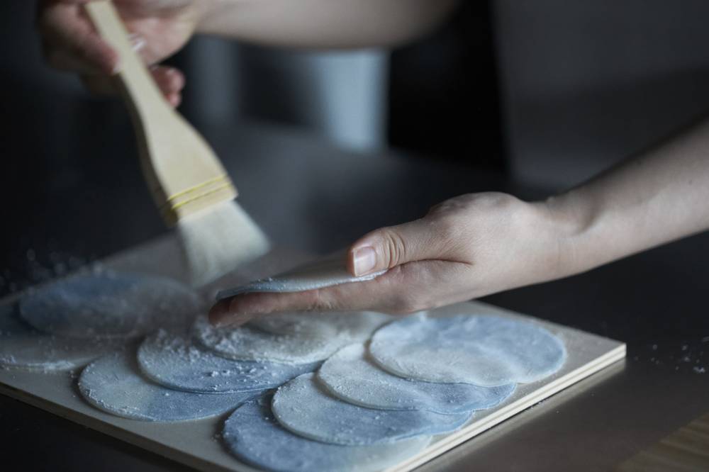 Handle with care: Shiho Sakamoto gently brushes discs of mochi dough before shaping them into wagashi sweets. | HUE INC.
