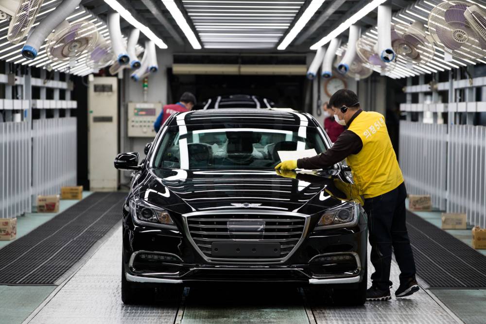 An employee performs final inspections on a Hyundai Motor Co. Genesis luxury sedan on the production line at the company's plant in Ulsan, South Korea, in 2017. | BLOOMBERG