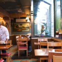 Culinary inheritance: Second-generation owner Shuji Go tidies the main dining room at Angkor Wat, which his father opened in 1982. | CHISATO TANAKA