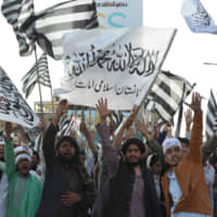 Jamiat Ulama-e-Islam Nazryati  party activists march as they celebrate the signing agreement between the United States and the Taliban during a rally in Quetta, Pakistan, on Sunday | AFP-JIJI