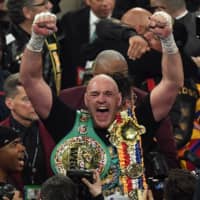 Tyson Fury celebrates after beating Deontay Wilder in the seventh round of their WBC heavyweight championship title fight on Feb. 22 in Las Vegas. The boxers will fight for the third time this summer, according to published reports. | AFP-JIJI