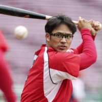 Carp infielder Kosuke Tanaka takes batting practice on Saturday at Mazda Stadium. | KYODO