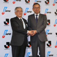 NPB Commissioner Atsushi Saito (left) and J. League Chairman Mitsuru Murai pose for photos at a news conference in Tokyo on Monday. | KAZ NAGATSUKA