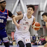 Akita forward Kengo Nomoto (right) attacks the basket against the B-Corsairs in Yokohama last month. | KAZ NAGATSUKA