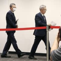 J. League Chairman Mitsuru Murai (left) and NPB Commissioner Atsushi Saito leave at the conclusion of a news conference of the two leagues\' joint coronavirus task force on Monday in Minato Ward. | KYODO