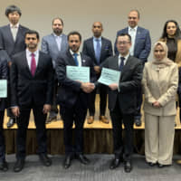 United Arab Emirates Ambassador Khaled Alameri (front row, third from left) shakes hands with Executive Officer and Global Head of the Corporate Division at Mizuho Bank Yasuhiko Hashimoto, and poses with Director of the Trade Promotion Department of the UAE\'s Ministry of Economy Mohammed Nasser Hamdan Al Zaabi (front row, second from left) and others during the UAE Business Seminar: Under the Framework of Comprehensive Strategic Partnership (CSP) event, held on Feb. 14, in Tokyo. The event was co-hosted by the UAE Embassy in Japan and Mizuho Bank to present new partnership and business opportunities in various fields between the UAE and Japan under the new CSP joint cooperation strategy. | PHOTO COURTESY OF THE UAE EMBASSY