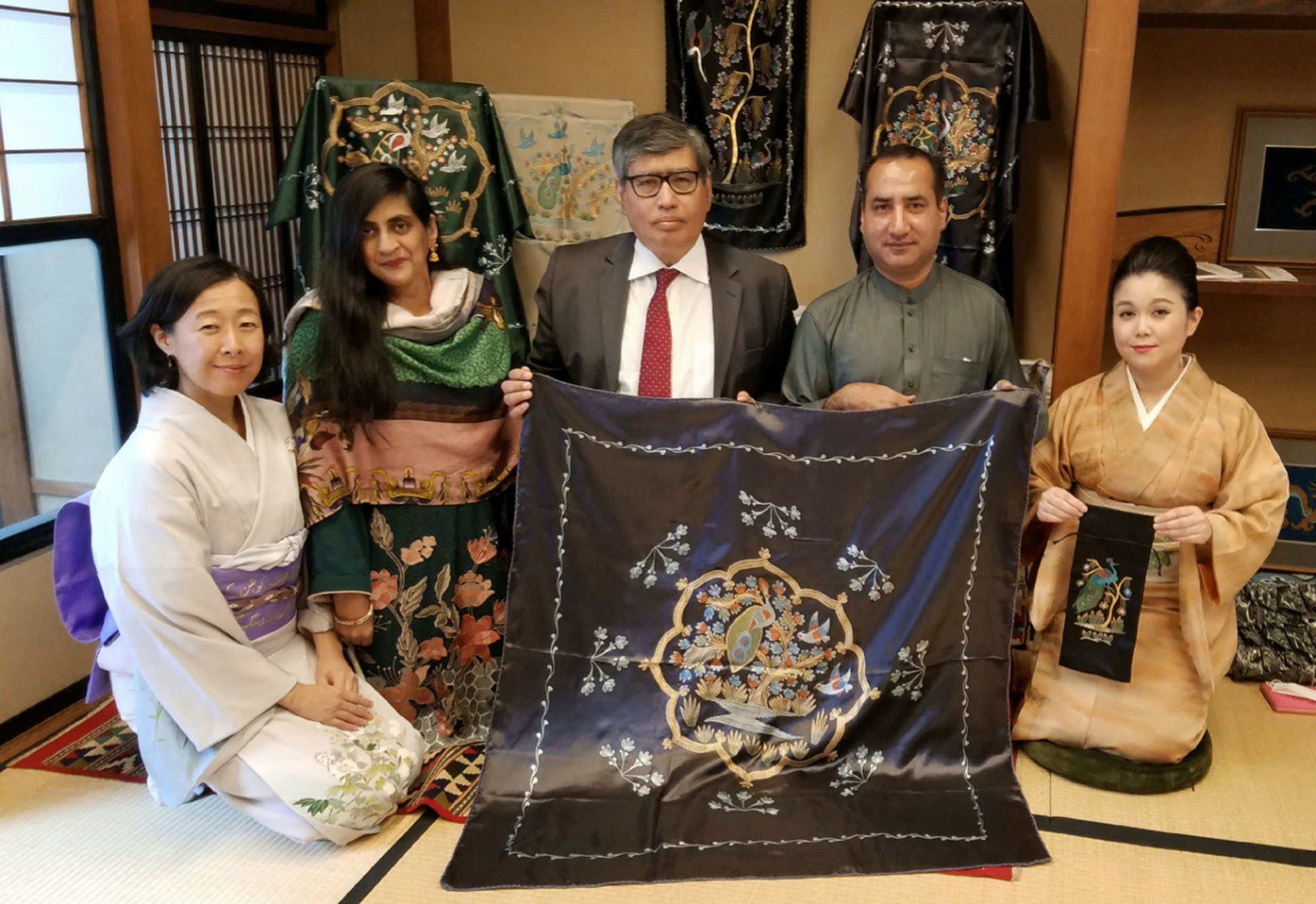 Ambassador of Pakistan Imtiaz Ahmad (center) and his wife Sadia Ahmad (second from left) pose with wax painter Fayyaz Ahmad (second from right), wax painting obi producer Motoko Matsuura (left) and organizer and President of International Cultural Exchange Japan (ICEJ) Maki Yamamoto-Arakawa (right) at Kudan House in Tokyo on Feb 28. | PHOTO COURTESY OF ICEJ