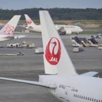 Japan Airlines Co. executives will voluntarily take a 10 percent cut in monthly remuneration from April to June as a cost-cutting measure. | BLOOMBERG
