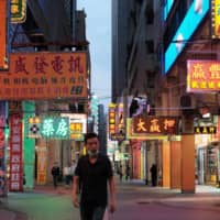 A man walks on an empty road near casinos in Macao on March 24. | REUTERS