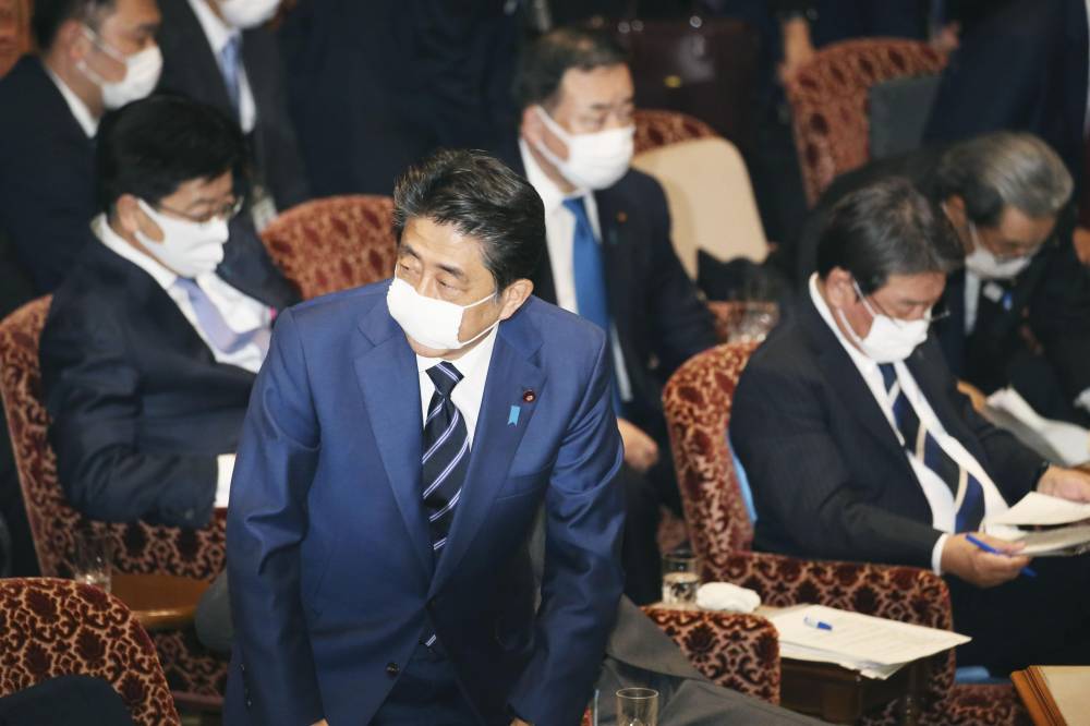 Prime Minister Shinzo Abe's decision to distribute two cloth masks to each household has drawn fire online, with many seeing it as out of touch with reality. | KYODO
