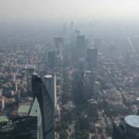 Air pollution clouds the sky over Mexico City on Monday. | AFP-JIJI