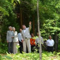 Back to basics: Emperor Akihito and Empress Michiko listen to C.W. Nicol as they walk together in the Afan Trust’s woods outside Kurohime, Nagano Prefecture, in June 2016. | COURTESY OF THE C.W. NICOL AFAN WOODLAND TRUST
