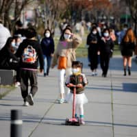 A girl rides a kick scooter at a park in Seoul on Friday.  | REUTERS