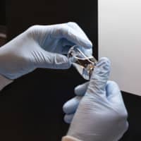 A vial of the drug remdesivir is inspected at a Gilead manufacturing site in the United States. | GILEAD SCIENCES / AP