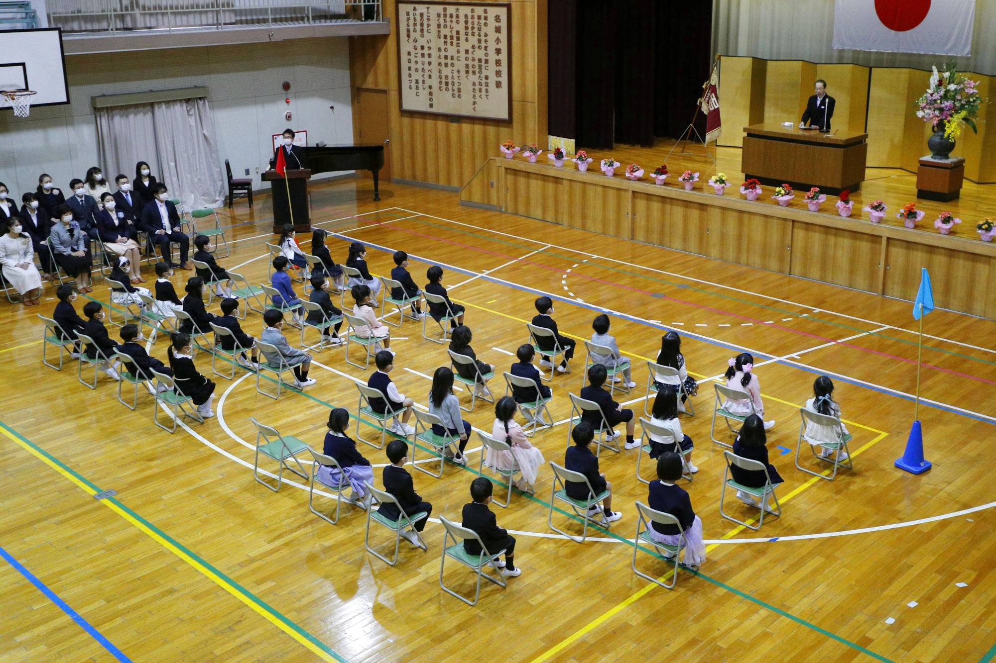 Children attend the entrance ceremony of an elementary school in Nagoya on Monday. | GETTY IMAGES