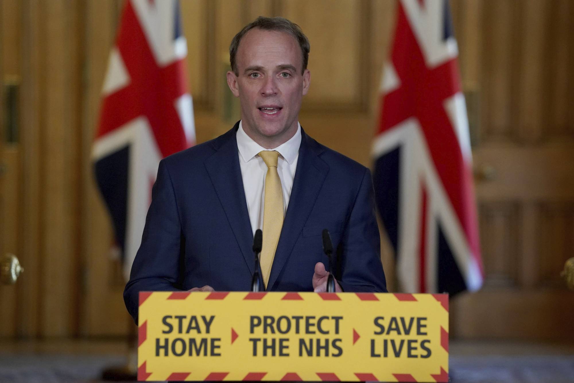 U.K. Foreign Secretary Dominic Raab speaks during a media briefing on coronavirus in London on Tuesday. | 10 DOWNING STREET / VIA AP