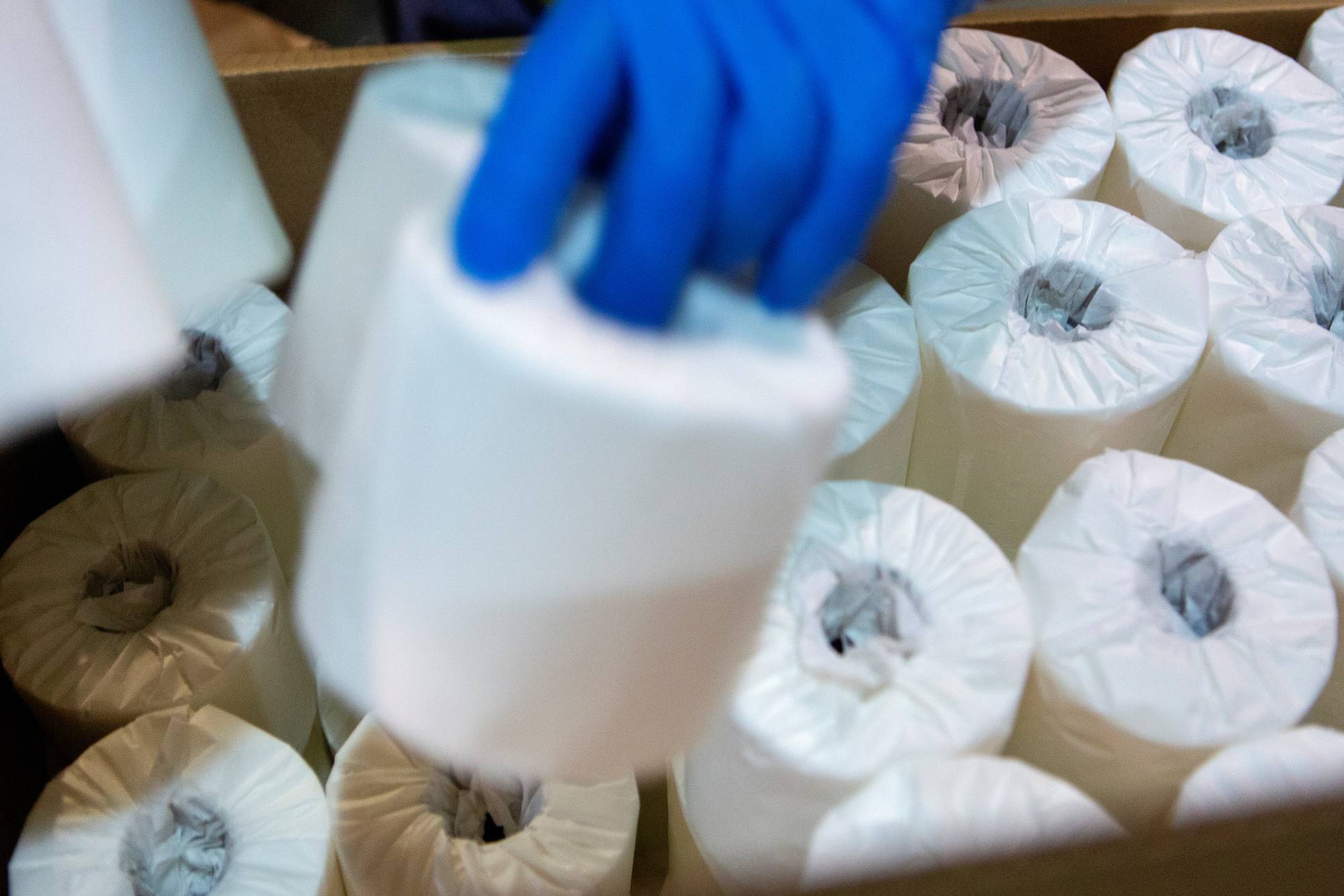 A worker boxes rolls of individually wrapped toilet paper to be shipped in Bangor, Maine, on Tuesday.  | REUTERS