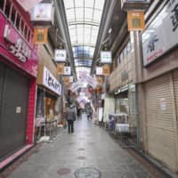 Photo shows an uncrowded shopping street in the city of Osaka on Thursday.  | KYODO