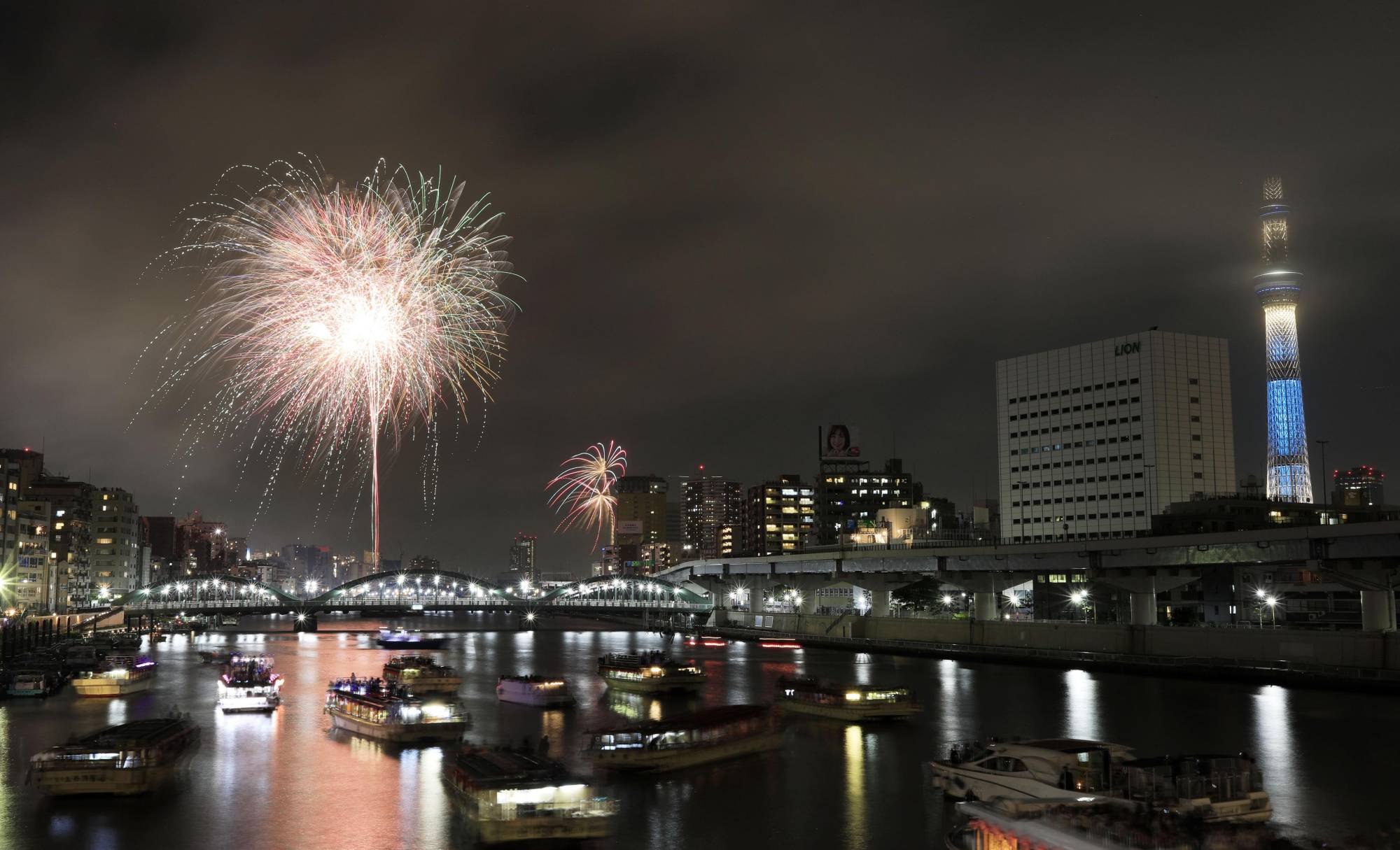 Fireworks are displayed over the Sumida River in Tokyo last July. The coronavirus pandemic has forced firework displays and other summer events across the country to be canceled. | KYODO
