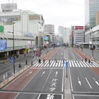 A near-deserted street in front of Shinjuku Station in central Tokyo on Sunday afternoon. | KYODO