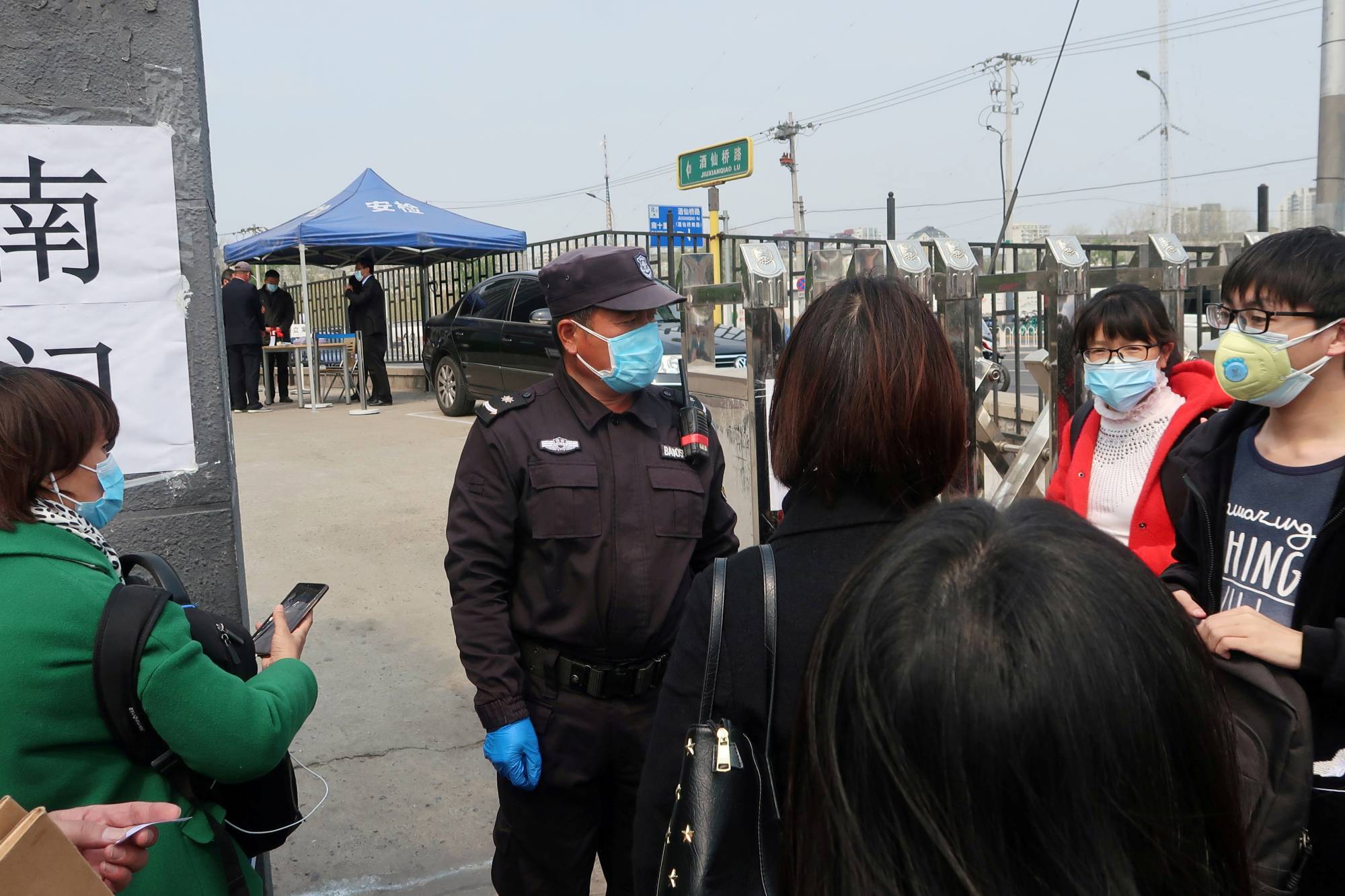People wait at an entrance to a labor arbitration office in Beijing on Thursday.  | REUTERS