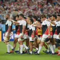 Brave Blossoms captain Michael Leitch (left) leads his teammates off the pitch before their Rugby World Cup Pool A match against Samoa on Oct. 5 in Toyota, Aichi Prefecture. | DAN ORLOWITZ