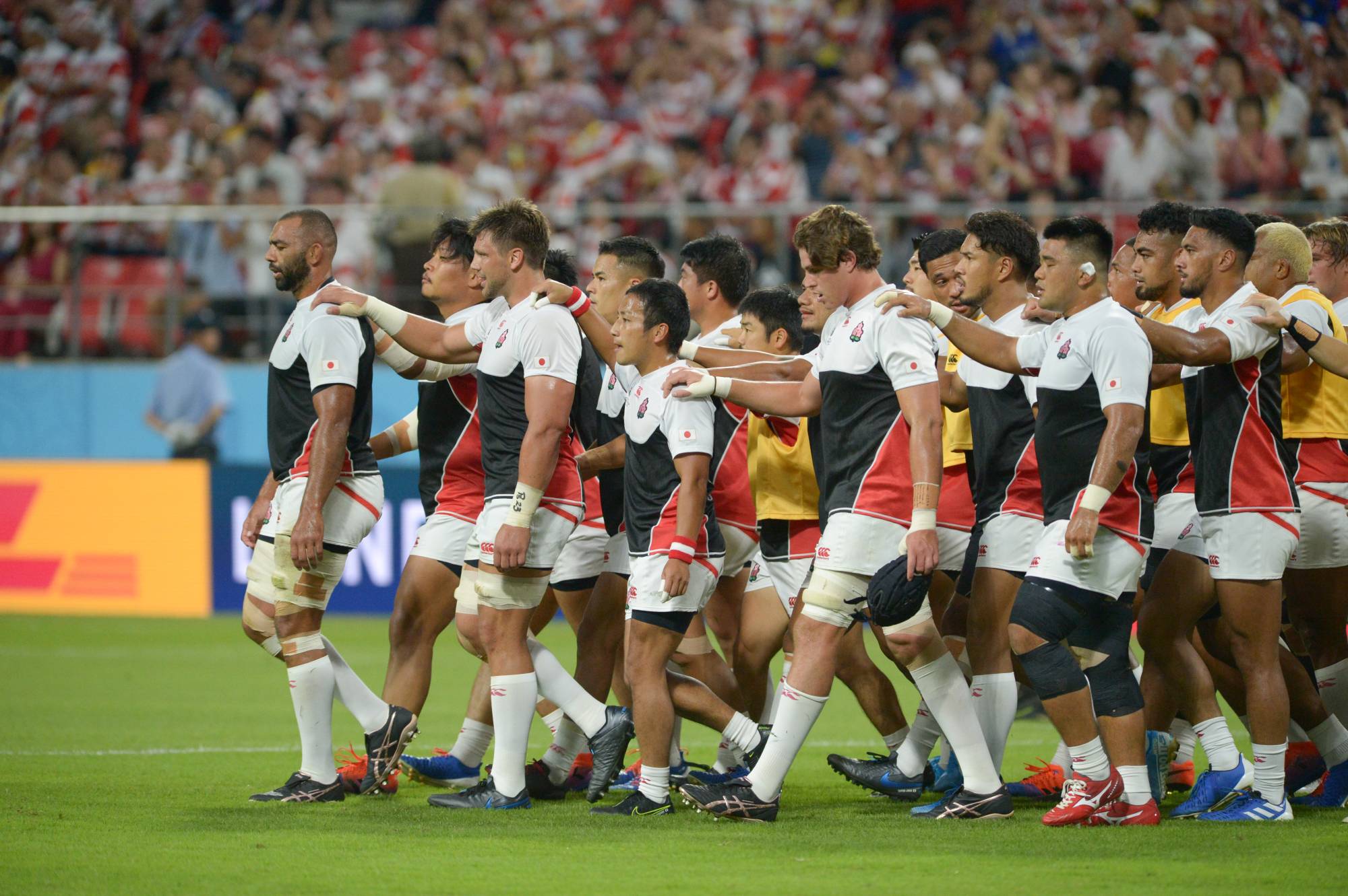 Brave Blossoms captain Michael Leitch (left) leads his teammates off the pitch before their Rugby World Cup Pool A match against Samoa on Oct. 5 in Toyota, Aichi Prefecture. | DAN ORLOWITZ