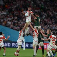 Michael Leitch (above, left) is lifted into the air during a lineout in the 2019 Rugby World Cup quarterfinal between Japan and South Africa on Oct. 19, 2019, at Tokyo Stadium. | DAN ORLOWITZ