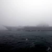The Chinese aircraft carrier Liaoning takes part in a naval parade off the eastern port city of Qingdao last April to mark the 70th anniversary of the founding of Chinese People\'s Liberation Army Navy. | REUTERS