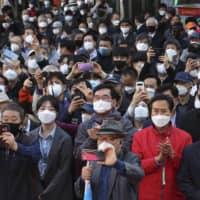 People gather for a speech by the main opposition United Future Party\'s candidate Hwang Kyo-ahn in Seoul on Monday.  | AP