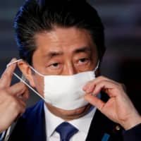 Prime Minister Shinzo Abe arrives at his official residence in Tokyo on April 6 to address the media on the government’s response to the coronavirus outbreak. | REUTERS