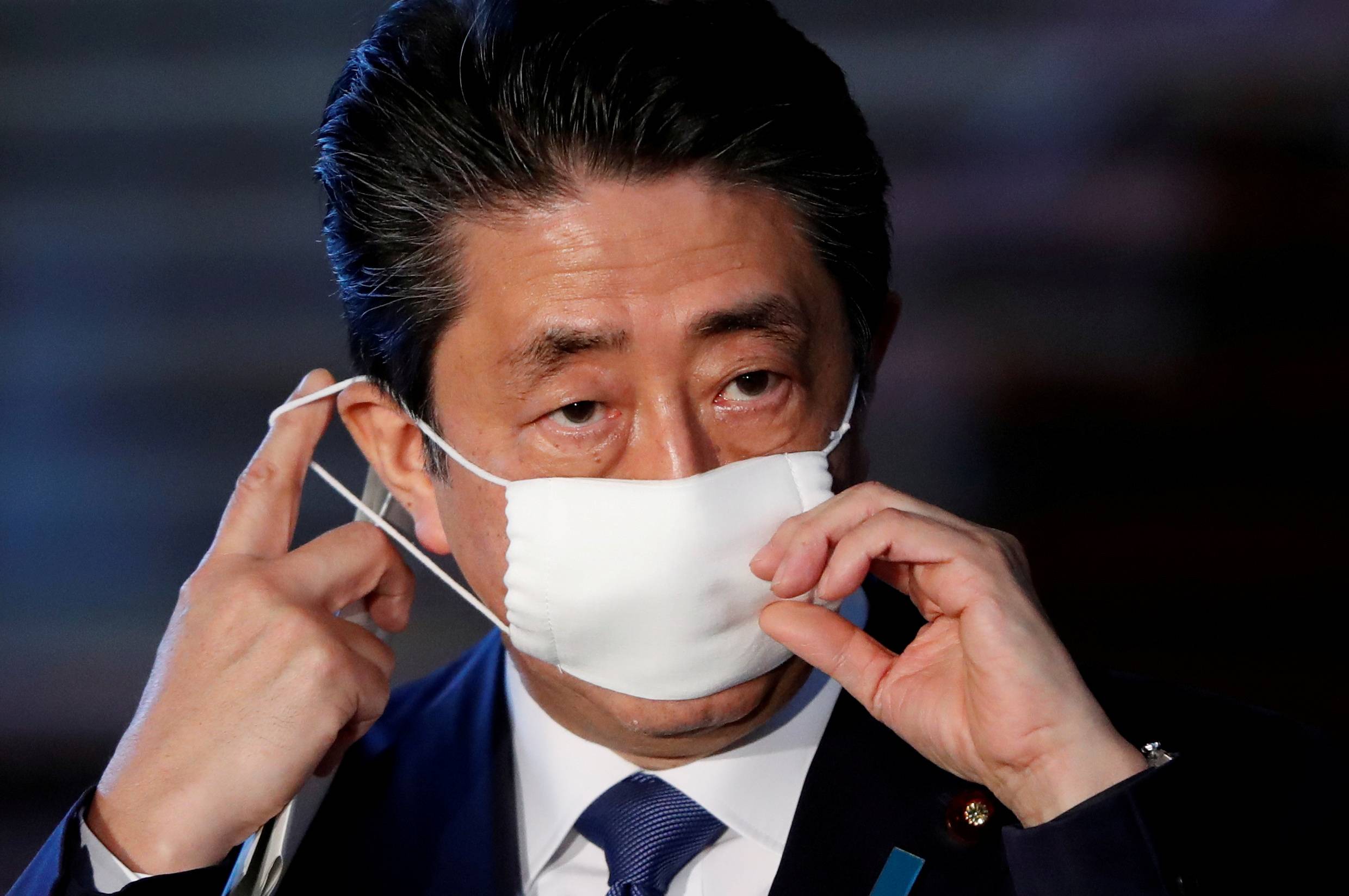 Prime Minister Shinzo Abe arrives at his official residence in Tokyo on April 6 to address the media on the government’s response to the coronavirus outbreak. | REUTERS