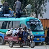 Islamic worshippers leave after attending a three-day annual Tablighi Jamaat religious gathering
in Lahore, Pakistan, on March 13. Pakistani authorities are searching for tens of thousands of
worshippers who attended the event just as COVID-19 was taking root in Pakistan. | AFP-JIJI