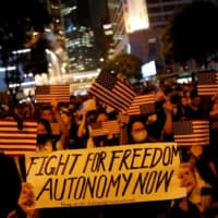 Anti-government demonstrators march in protest against the invocation of emergency laws in Hong Kong in October. | REUTERS