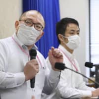 Hokkaido University professor Hiroshi Nishiura speaks at a news conference at the health ministry Wednesday. | KYODO