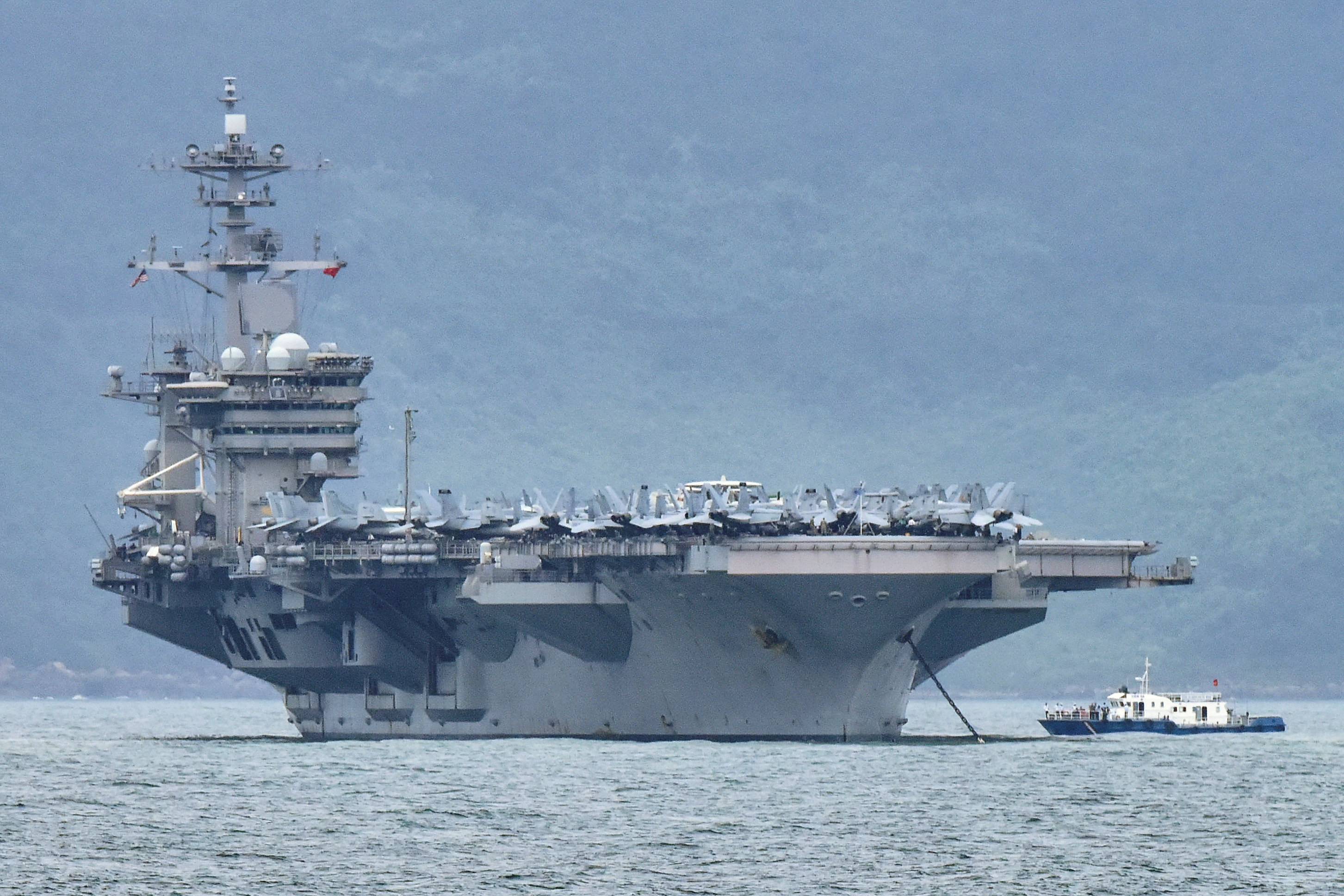 The USS Theodore Roosevelt enters the port in Da Nang, Vietnam, March 5. The United States has said it is 'seriously concerned' about China's reported sinking of a Vietnamese fishing boat. | REUTERS