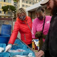 Fish are sorted into plastic baskets and displayed for sale in Nice, France, on Thursday. | AFP-JIJI