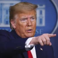 U.S. President Donald Trump speaks during a news conference at the White House on Saturday. | BLOOMBERG