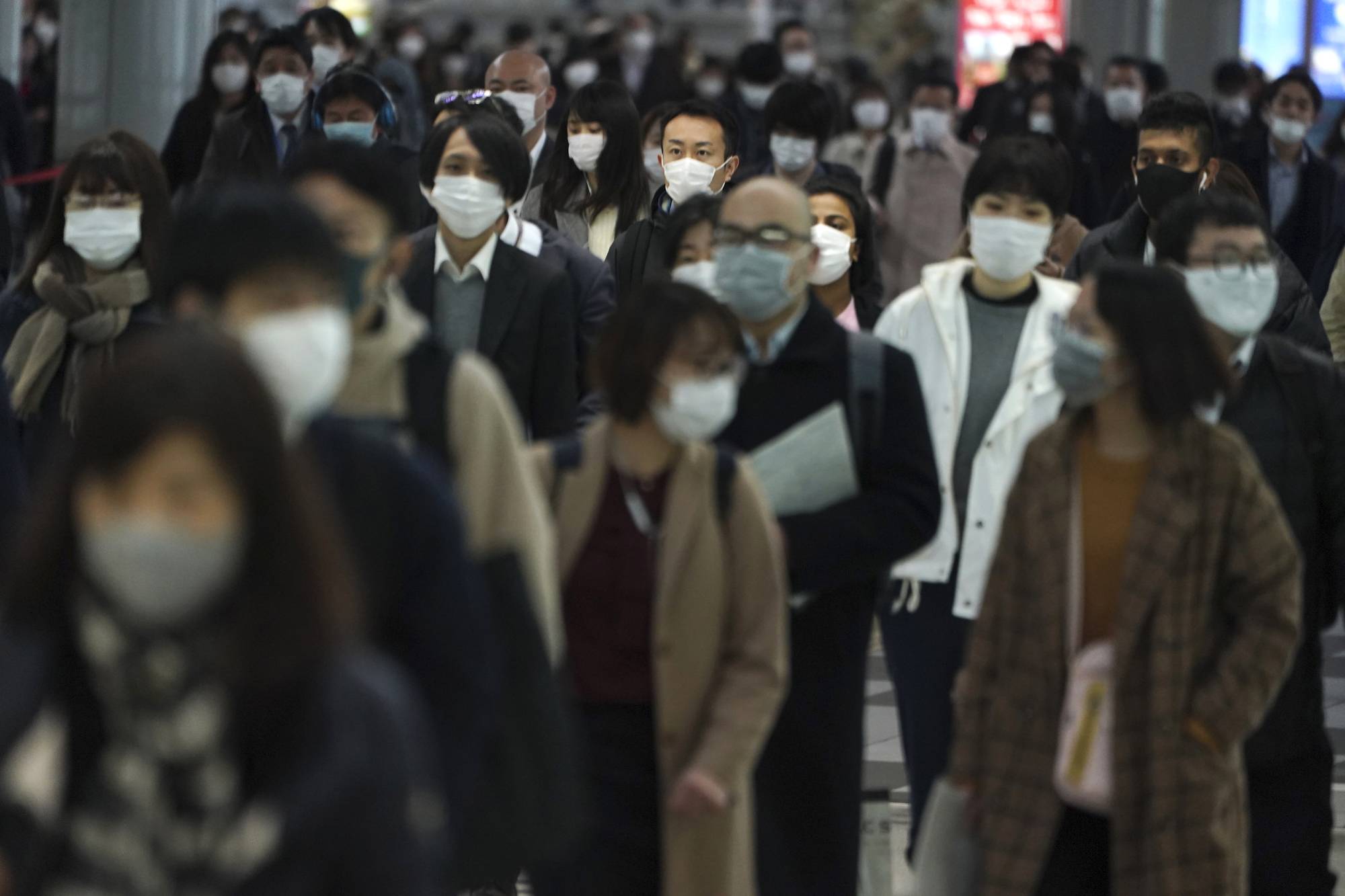 Social habits in Japan such as wearing face masks during seasonal flu outbreaks might play some role in hindering transmission of the coronavirus. | AP