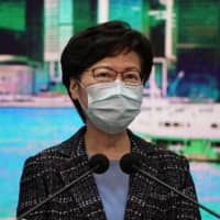 Hong Kong Chief Executive Carrie Lam listens to reporters questions during a news conference on Tuesday.  | AP