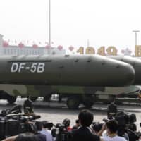 Military vehicles carrying DF-5B intercontinental ballistic missiles travel past Tiananmen Square during the military parade marking the 70th founding anniversary of People\'s Republic of China, on its National Day in Beijing on October 1. | REUTERS