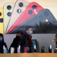 People shop in an Apple Store in Shanghai in January.  | REUTERS 