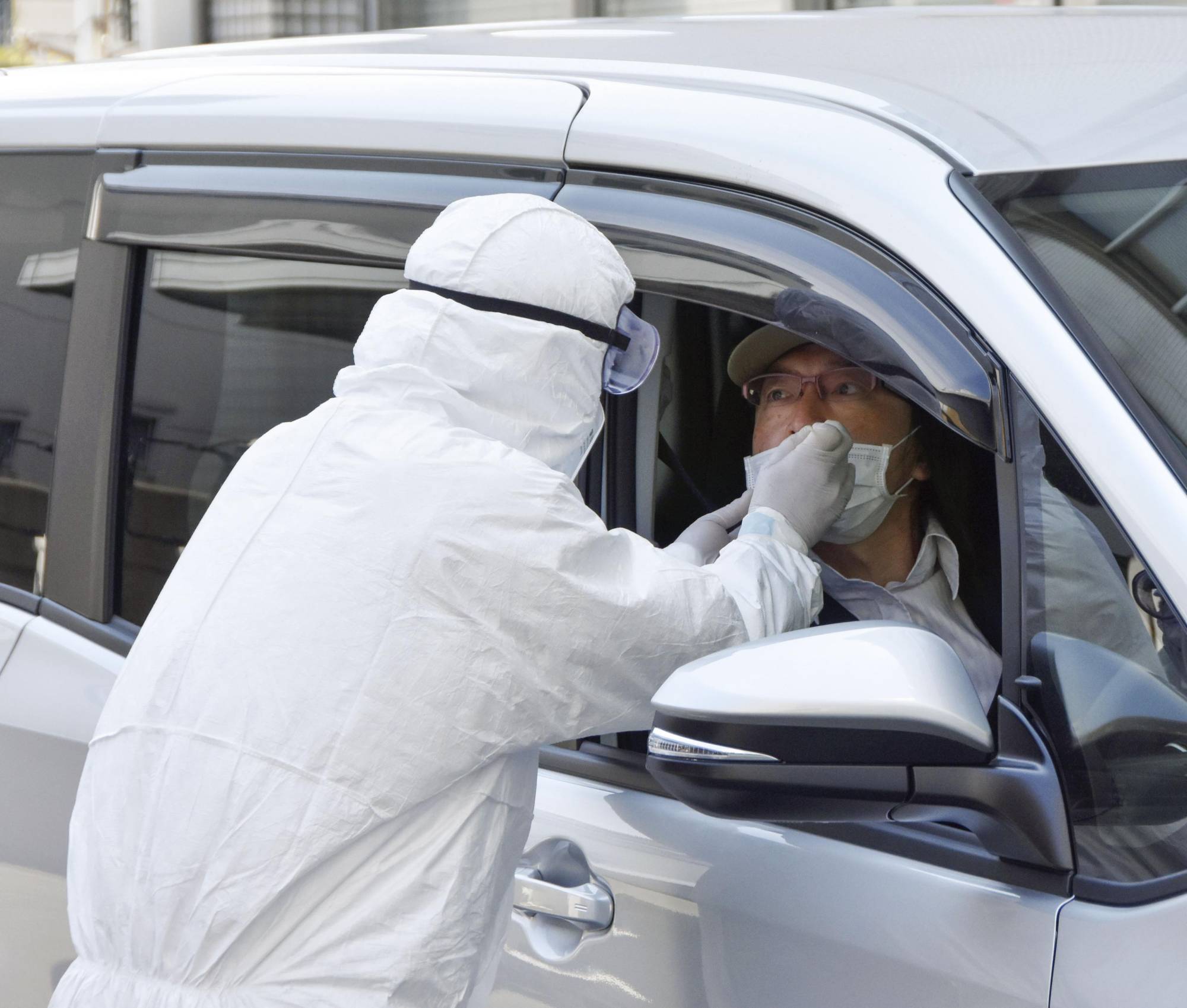 Drive-thru coronavirus testing is demonstrated in Osaka on Thursday. The Osaka Prefectural Government is looking to increase the number of tests it conducts to help contain the spread of the virus. | KYODO