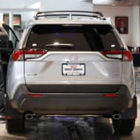 Potential customers look at a Toyota Motor Corp. RAV4 sport utility vehicle at a dealership in Orem, Utah, on April 6. | BLOOMBERG