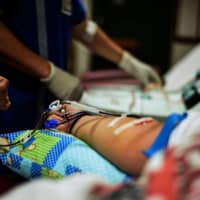 With more Filipinos becoming sick with COVID-19, the consequences of a medical brain drain are weighing on the health care industry. | AFP-JIJI