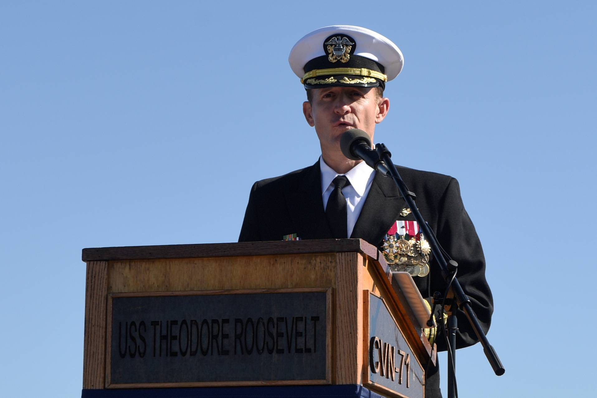 Capt. Brett Crozier addresses the crew for the first time as commanding officer of the aircraft carrier USS Theodore Roosevelt during a change of command ceremony on the ship’s flight deck in San Diego on Nov. 1. | U.S. NAVY / VIA REUTERS