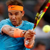 Rafael Nadal hits a return against Stefanos Tsitsipas during the Madrid Open semifinals on May 11, 2019. | REUTERS