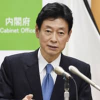 Economy minister Yasutoshi Nishimura speaks at a news conference in Tokyo on Thursday. | KYODO