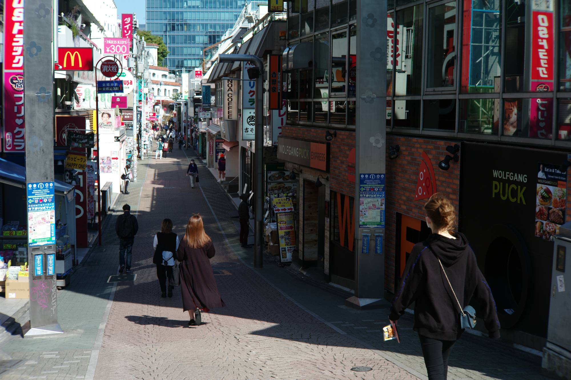 Just a handful of pedestrians are seen on the popular Takeshita-dori shopping street in Tokyo's Harajuku area on Sunday. | RYUSEI TAKAHASHI