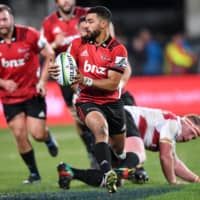 The Crusaders\' Richie Mo’unga avoids a tackle from Jaques Van Rooyen of South Africa\'s Lions during the Super Rugby Final in Christchurch, New Zealand, on Aug. 4, 2018. | REUTERS
